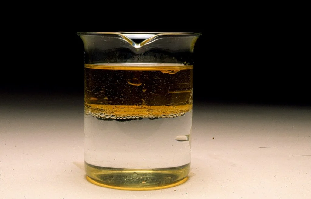 Ejemplo de mezcla heterogénea, agua con aceite, tipo de mezcla donde se pueden apreciar y diferenciar los compuestos que la conforman.